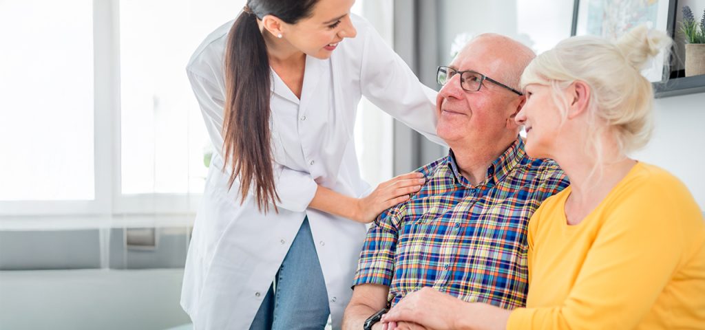 Palliative care in Hartwell, Georgia with a compassionate caregiver supporting a senior couple in a comfortable, home-like setting